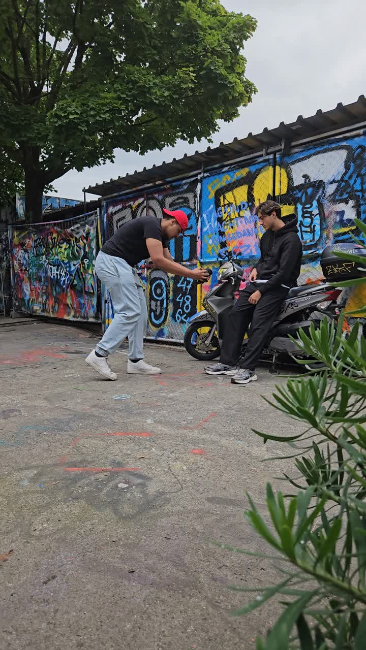 Filming a scene by a graffiti wall