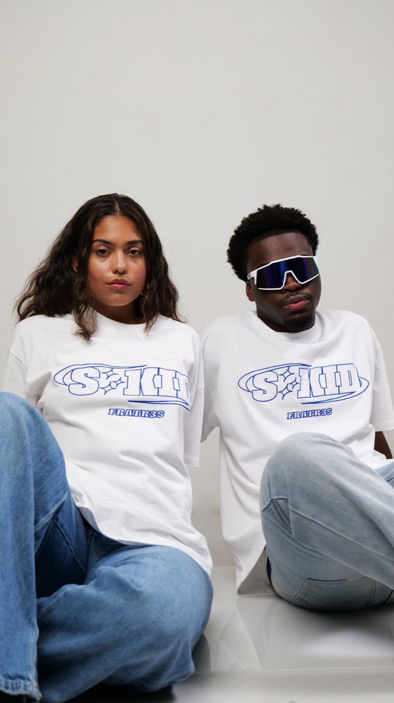 Two models sitting side by side in Fratr3s t-shirts