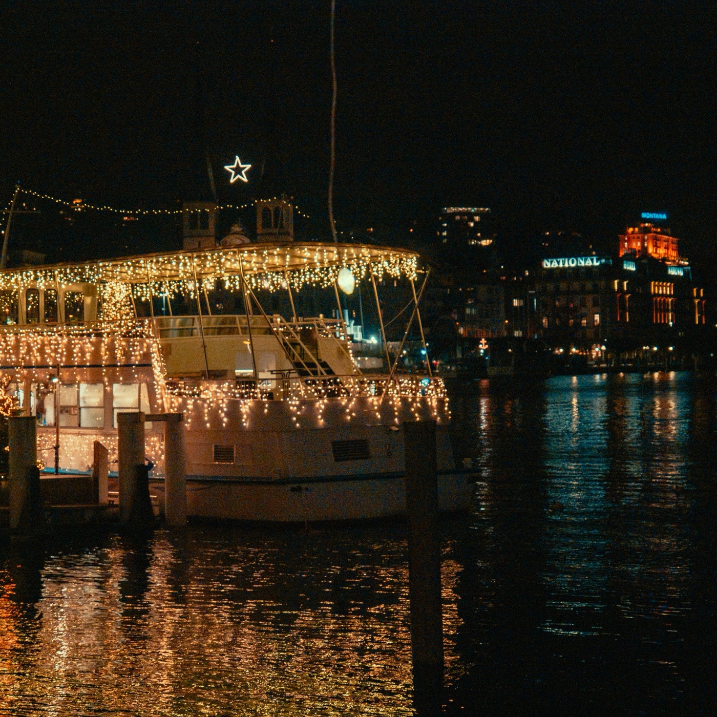 Lit-up boat on the lake at night