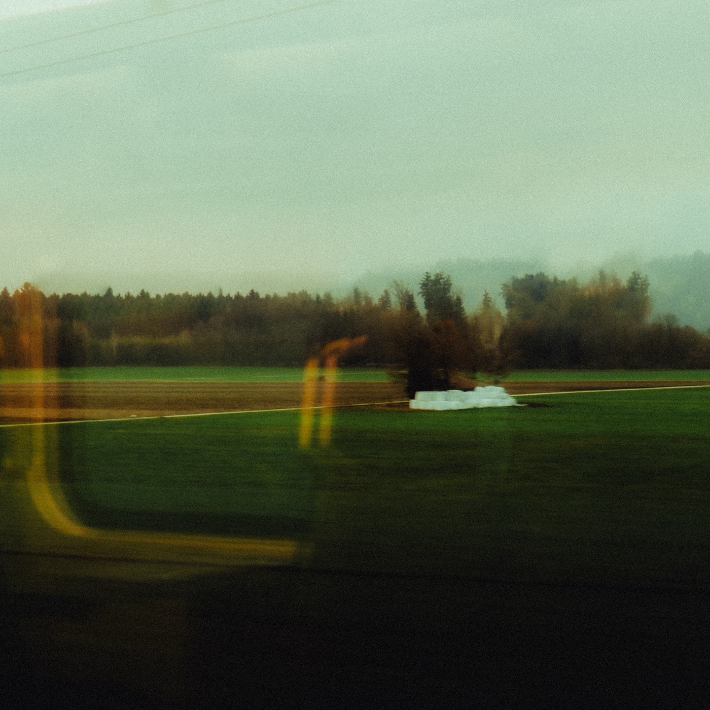 Misty field seen through a train window