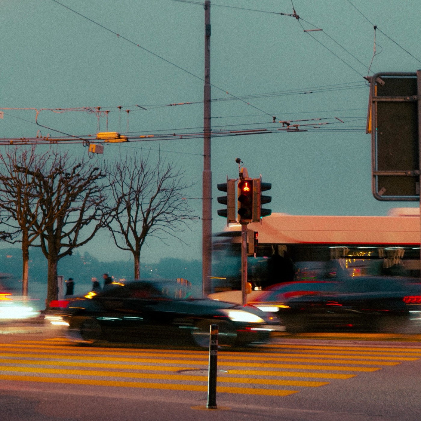 Cars blurring past a crossing at a traffic light