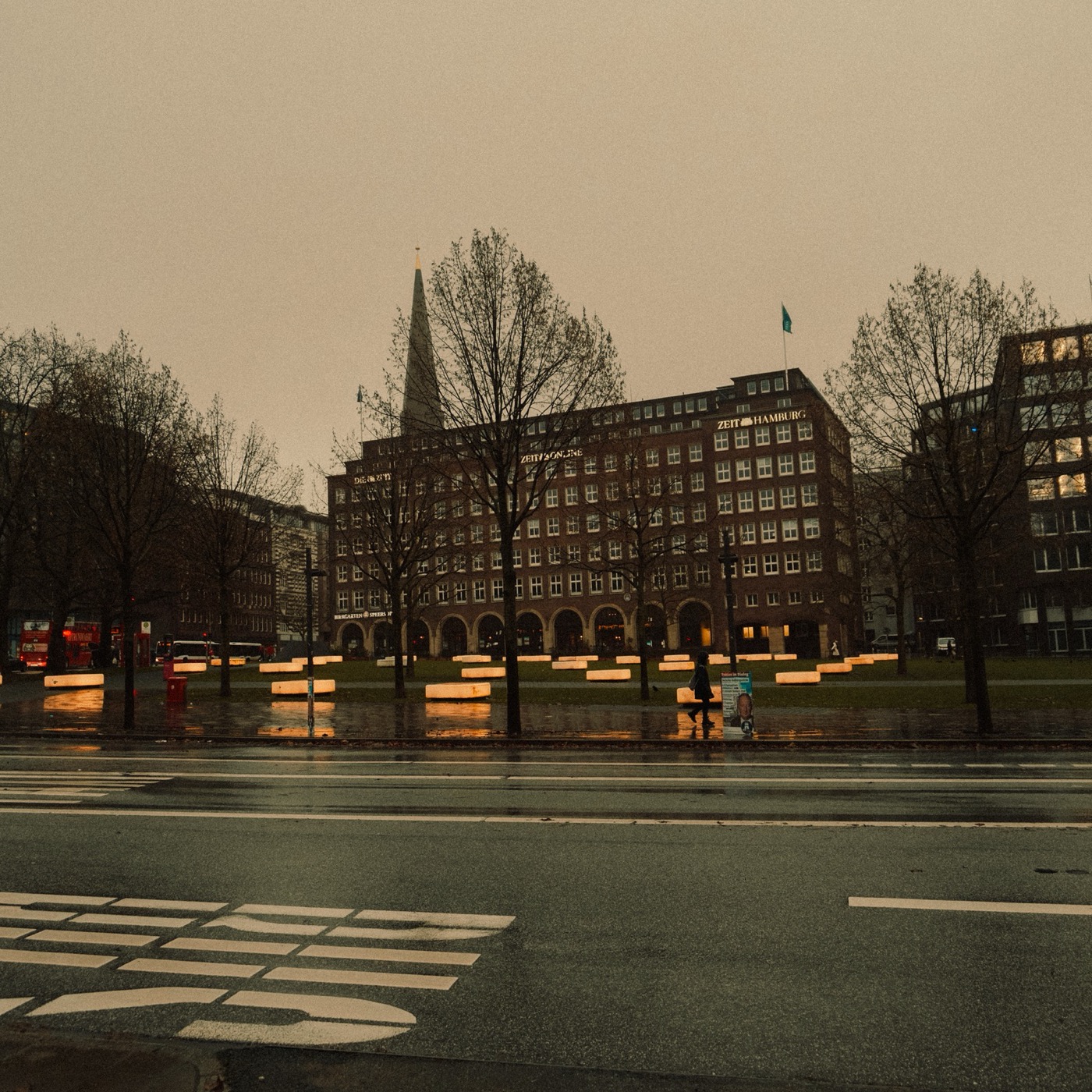 Wet city square with a church spire